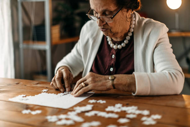 istock Old woman playing puzzle game 1162426092