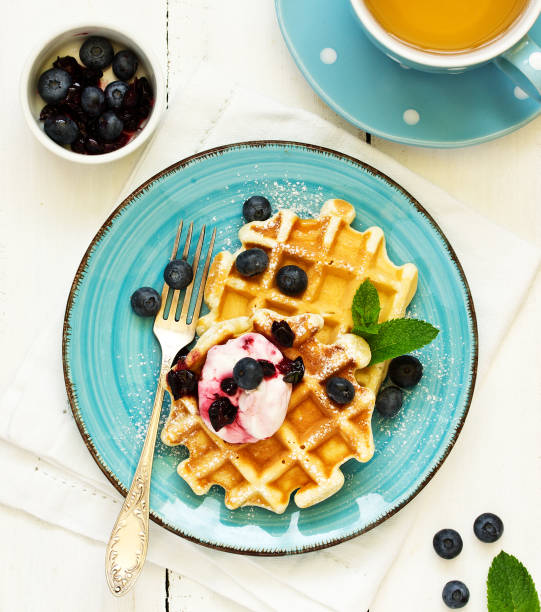 istock Homemade waffles with a sprig of currants. White background. 1162426132