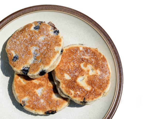 istock Three Welsh Cakes on a plate isolated on a white background. 1162427563