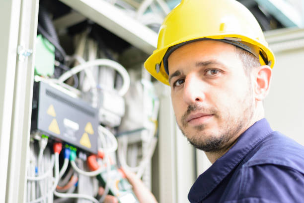 istock Electrician connecting cable to the switch 1162430048