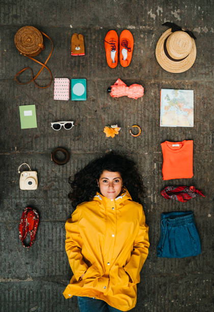istock Young adult woman lying down with clothes and various objects 1162430969
