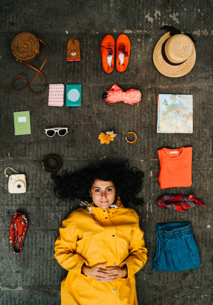 istock Young adult woman lying down with clothes and various objects 1162430973