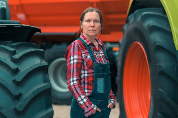 istock Female farmer and tractor 1162432580