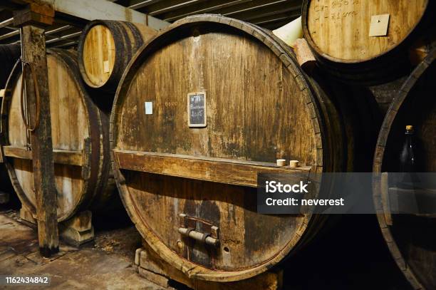 Big Old Oak Casks Of Pommeau Of Calvados In A Cellar Stock Photo - Download Image Now