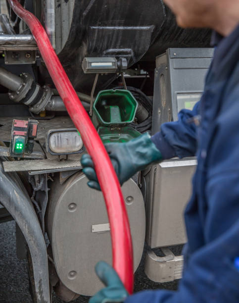 istock Heating oil delivery, pipework from the oil tanker operative dealing with delivery 1162437478
