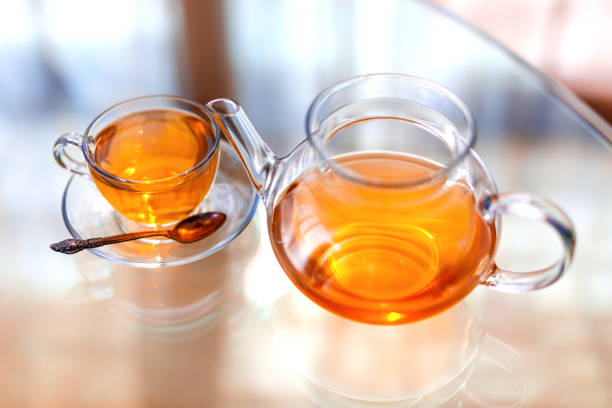 istock Transparent glass teapot and cup with spoon 1162438573