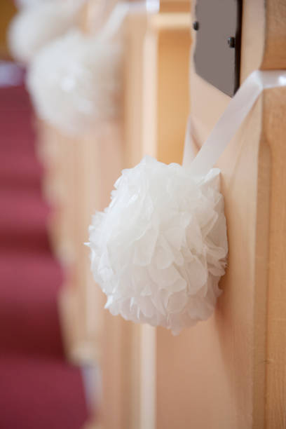 istock Round white flowers on a pew 1162438743