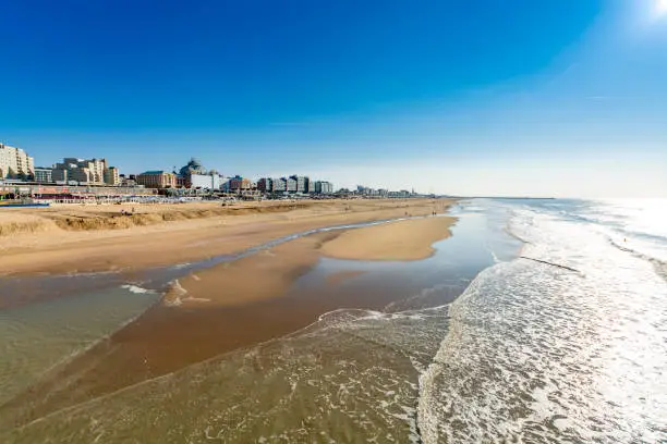 Sunny day on North sea beach in Netherlands in Scheveningen, tourist and vacation destination