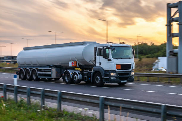 Tanker truck in motion on the motorway Tanker truck in motion on the motorway with orange sky in the background heating oil photos stock pictures, royalty-free photos & images