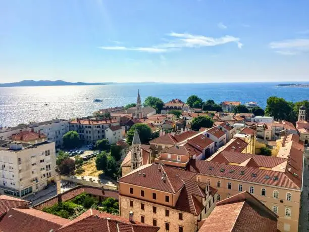 Photo of A beautiful view looking down on the old town of Zadar, Croatia from the famous Bell Tower, with the beautiful Adriatic Sea in the background.