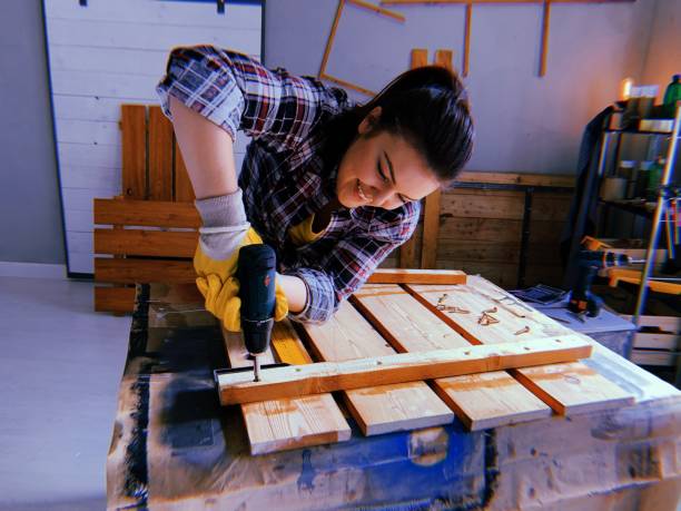 istock Woman screwing with drill 1162449552