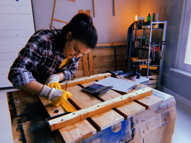 istock Woman measuring wooden piece 1162449667