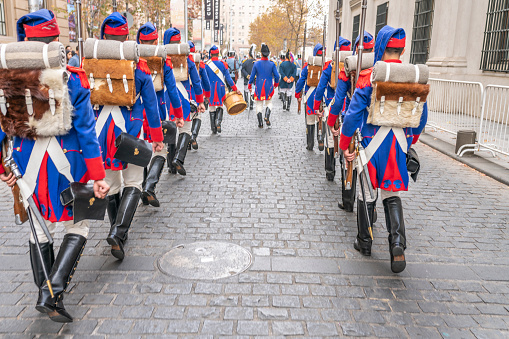 City: Santiago de Chile\nCountry Chile\n26/05/2019\nHeritage Day at Santiago de Chile city streets. Armed forces troops marching with classical blue, red and white uniforms and backpack walking formation