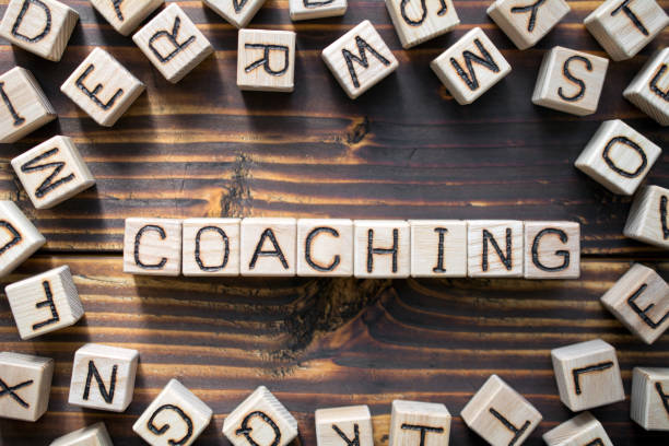 word coaching composed of wooden cubes stock photo