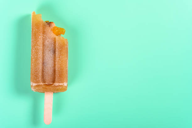 istock red bean popsicle with couple of bites on light green background 1162452878