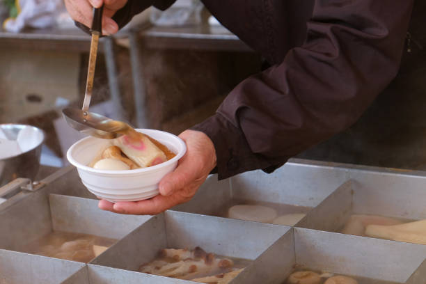 Close up men serving a bowl of oden Japanese hot pot