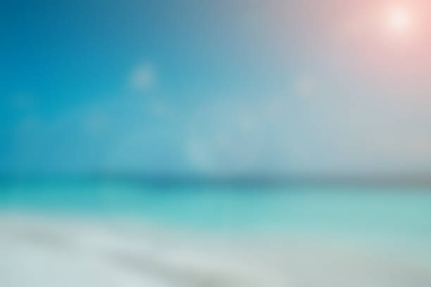 abstract blurred beautiful beach in sunny day with light effect and bright sky background for summer season collection design template concept