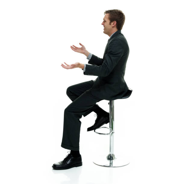 istock Businessman wearing a suit with necktie on white background sitting 1162455267