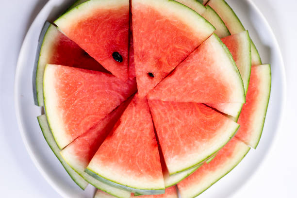 istock Slices of fresh watermelon on white marble background 1162455377