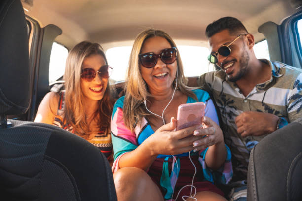 istock Friends watching video conference while traveling by car 1162456612