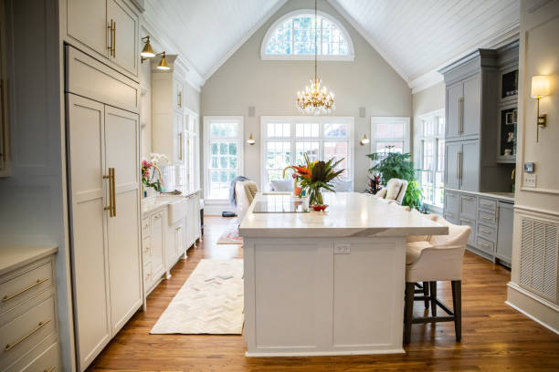 istock Open Concept Elegant and Spacious Kitchen with Marble Countertops, Chandelier, and Two Toned Cabinets 1162456678