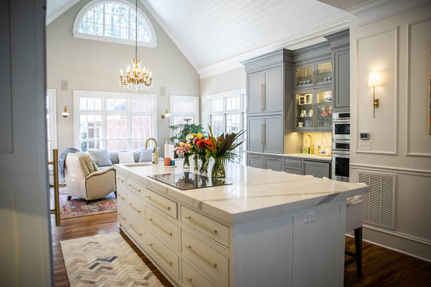 istock Open Concept Elegant and Spacious Kitchen with Marble Countertops, Chandelier, and Two-Toned Cabinets 1162457722