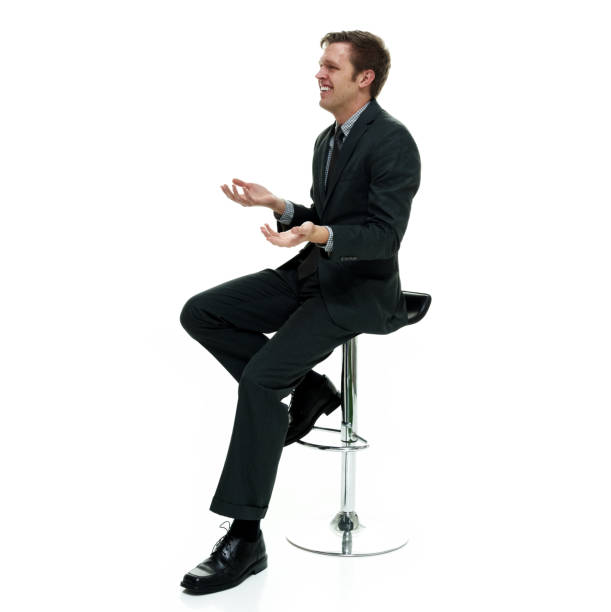 istock Businessman wearing a suit with necktie on white background sitting 1162458593