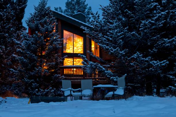 Chalet with lights on in winter snow at night