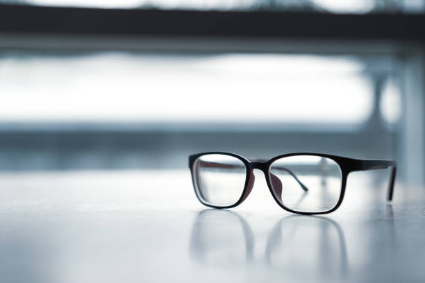 istock Pink classic eye glasses  on wooden table. 1162463901