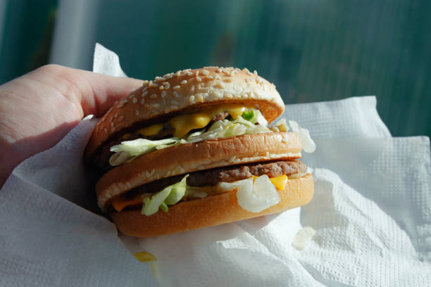 istock Big juicy burger with cheese in the hand 1162468152