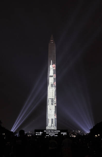 Apollo 11 Saturn V meets Washington Monument Celebration of the 50th anniversary of Apollo 11 landing, illumination of the east face of the Washington Monument with a 363-foot Saturn V. apollo 11 stock pictures, royalty-free photos & images