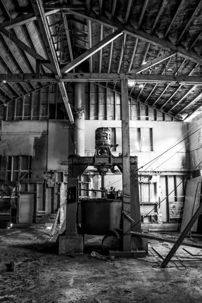 istock Black and White Machine in Abandoned Warehouse Building 1162470791
