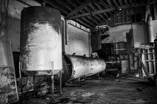 dwa stare zardzewiałe czołgi w opuszczonym magazynie czarno-białym - monterey california monterey county cannery row zdjęcia i obrazy z banku zdjęć
