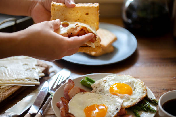 istock homemade healthy breakfast: Emmental cheese bacon sandwich, fried egg and asparagus 1162473627
