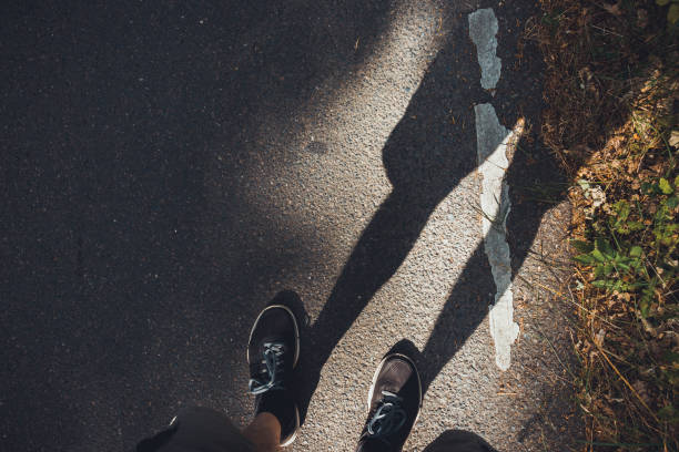 istock man looking down to his shoes on the road 1162473741