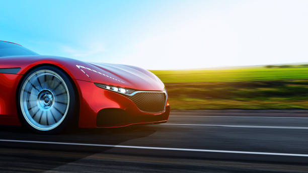 istock red car driving on a road 1162474570