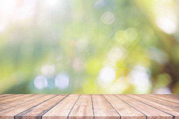 istock Abstract natural green bokeh background wood table 1162476124