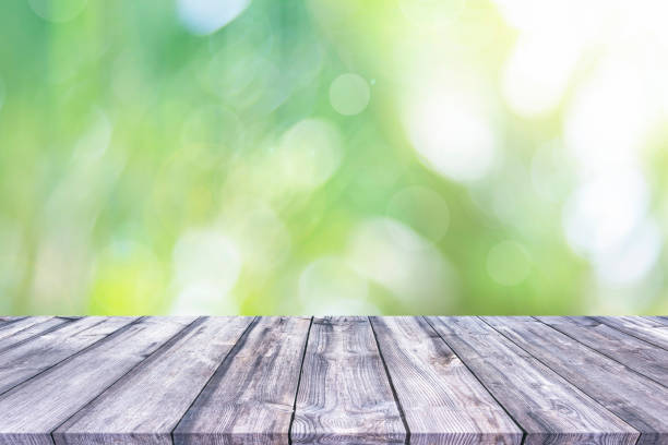 istock Abstract natural green bokeh background wood table 1162476129