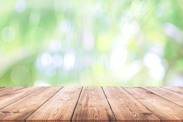 istock Abstract natural green bokeh background wood table 1162476130