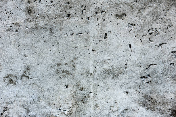 istock Texture of a concrete wall with cracks and scratches which can be used as a background 1162476221