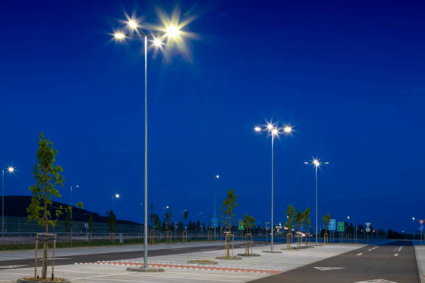 istock big modern empty parking lot with modern bright LED street lights at night 1162476998