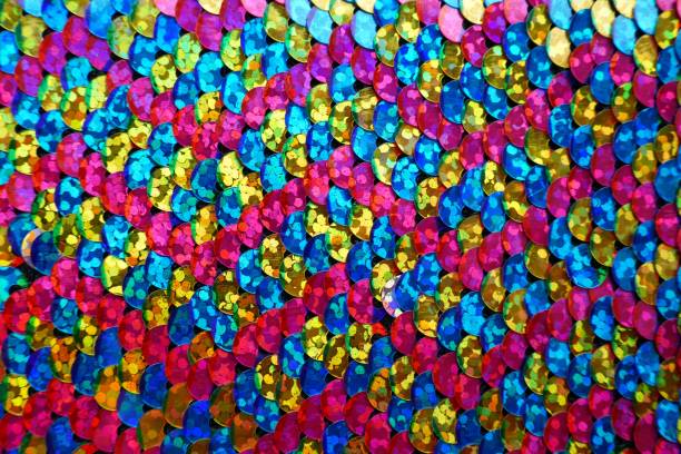 istock sequin zigzag pattern.Fish scales Sequin macro background in pink, yellow and blue tones.Shimmering sequins background 1162477984