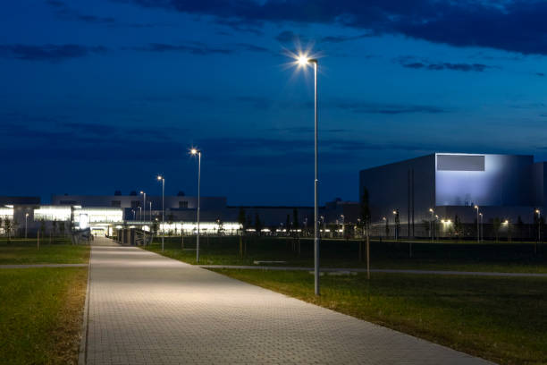 istock night empty walkway into modern industrial zone, with modern LED street light 1162478139
