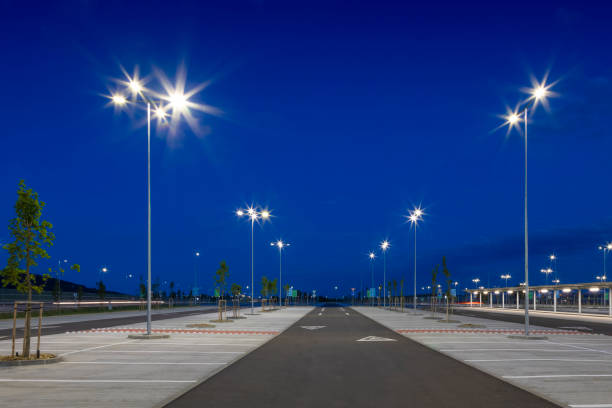 istock big modern empty parking lot with LED street lights at night 1162478862