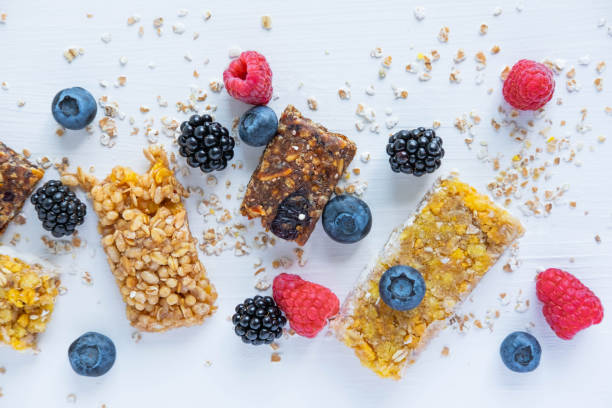 istock Pattern with cereal bars and blueberries, blackberries and raspberries with oatmeal. Healthy snacks and breakfasts 1162480007