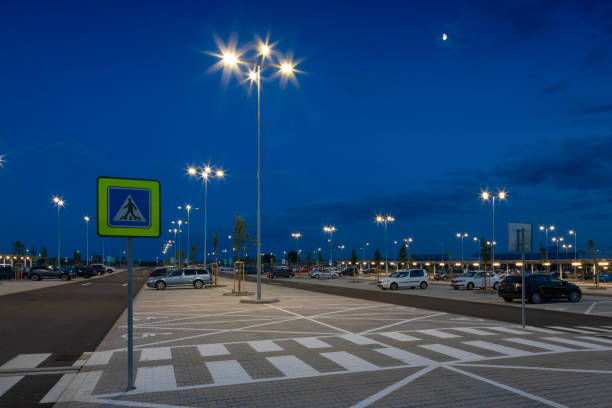 istock big modern empty parking area with LED street lights at night 1162480199