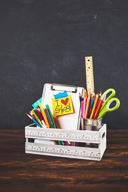 istock Back to school supplies in crate against weathered chalkboard 1162481064