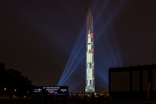 Washington DC, July 16 2019: Apollo 50: Go for the Moon show projects a 363-foot Saturn V rocket on the east face of the Washington Monument. This is to celebrate the 50th anniversary of mans landing on the moon.