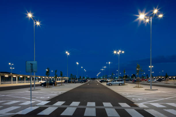 istock big modern empty parking area with LED street lights at night 1162481305