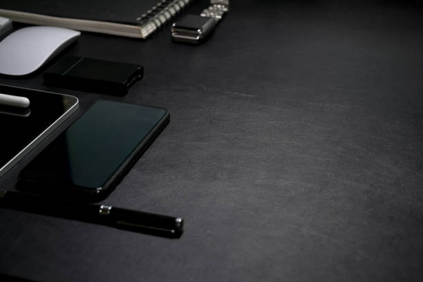 Dark leather desk top table with office supplies and copy space